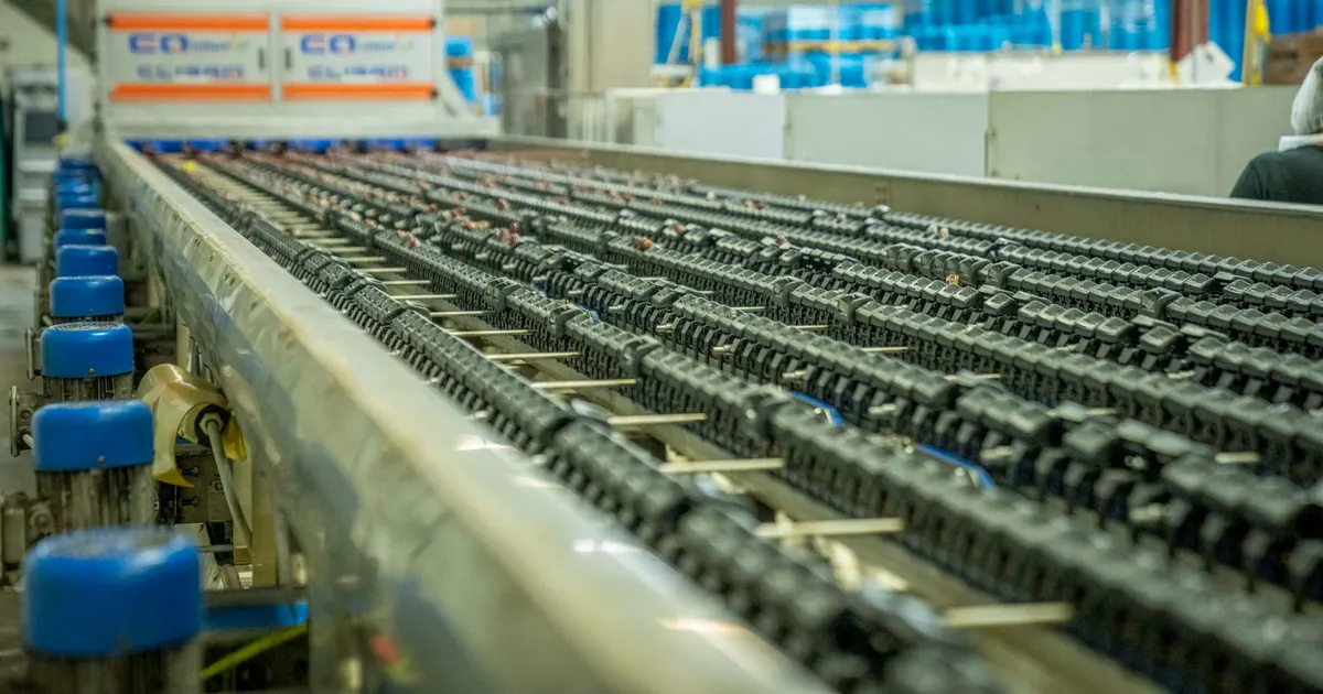 Conveyor line with chains on rails, the type of equipment where an acetal wear strip is fitted along the chain path